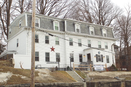 a white house up on a small hill